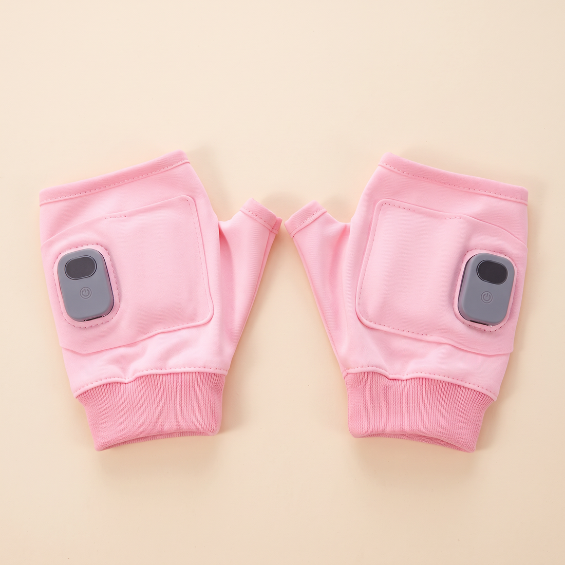 A pair of Cozy Loop heated fingerless gloves in blush pink